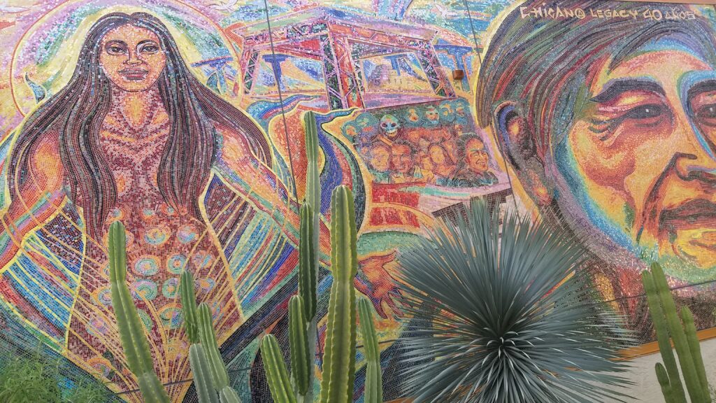 Colorful mosaic with the title "Chicano legacy 40 [years]", depicting the civil rights icon Cesar Chavez, a female spirit, a group of protesters, and Chicano Park